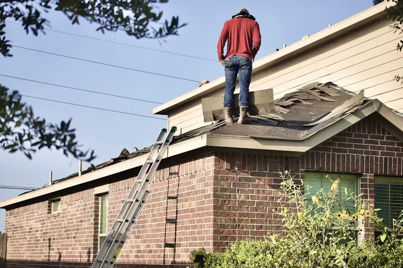Professional roofer working on a residential roof in Rushville